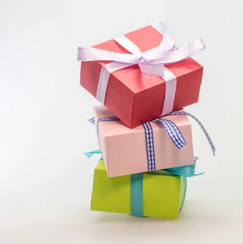 Three presents with bows stacked on one another