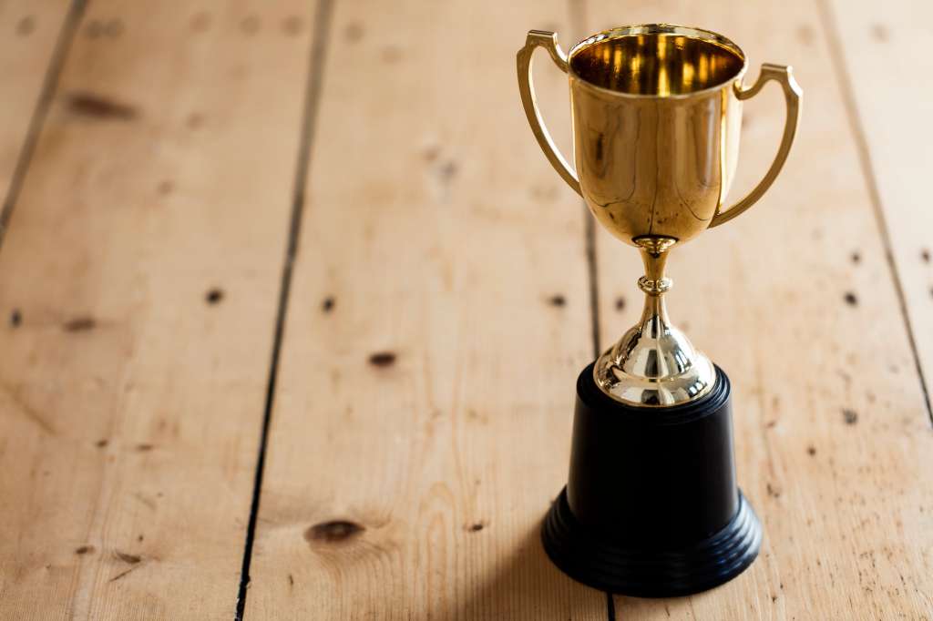 Gold winners trophy on a wooden background