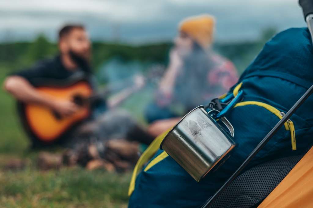 Close shot of a backpacks and a camping gear in the nature